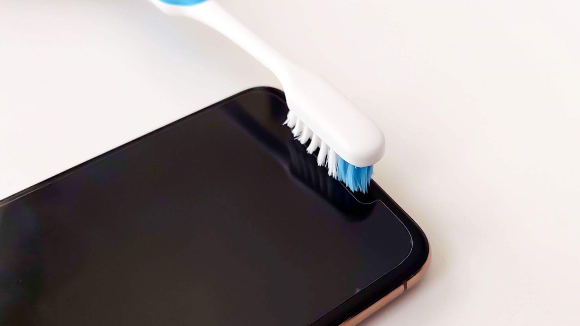 How to clean microphone on iPhone using a toothbrush